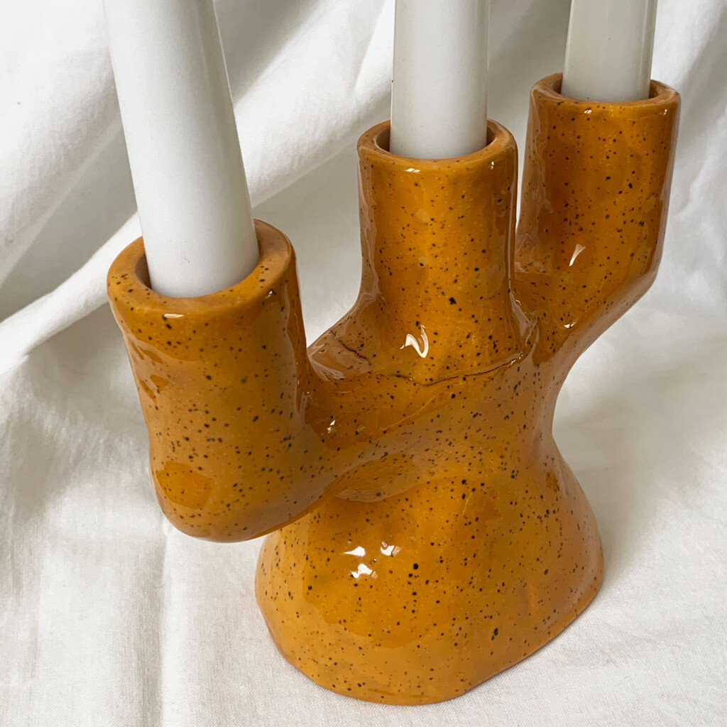 Orange three-armed candelabrum